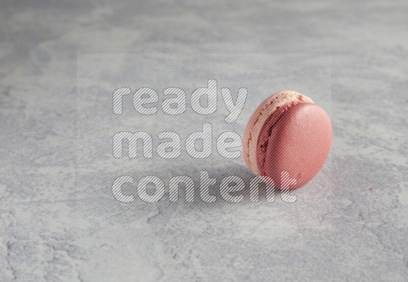 45º Shot of Pink Litchi Raspberry macaron on white  marble background