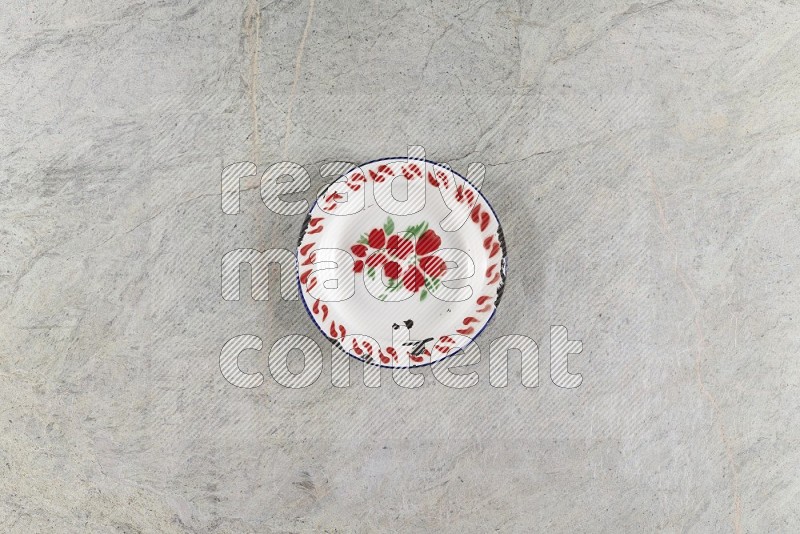 Top View Shot Of A Vintage Metal Plate On Grey Marble Flooring