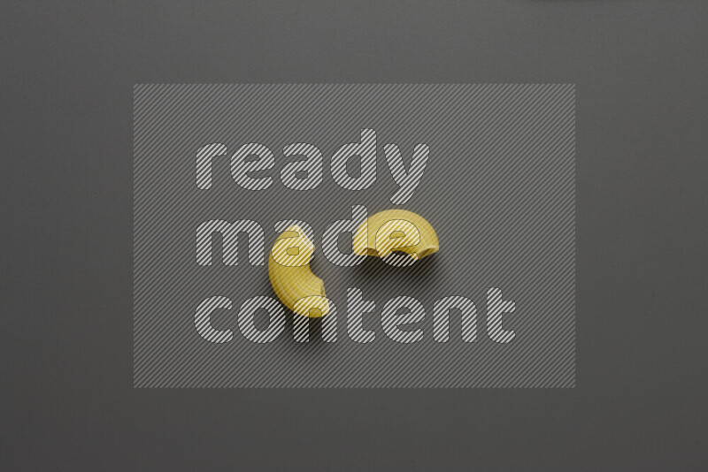 Elbow pasta on grey background