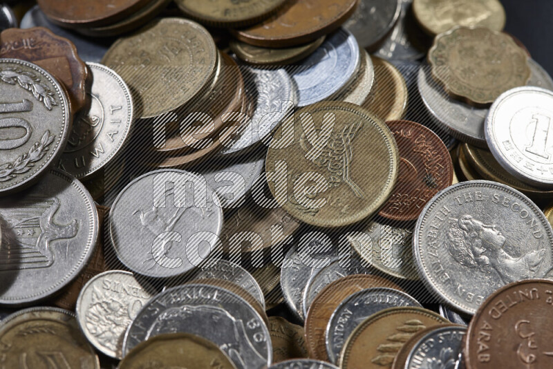A close-ups of random old coins on black background