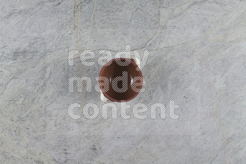 Top View Shot Of A Multicolored Pottery Pot On Grey Marble Flooring