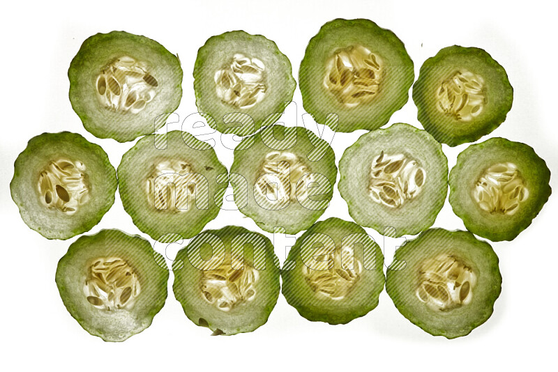 Cucumber slices on illuminated white background