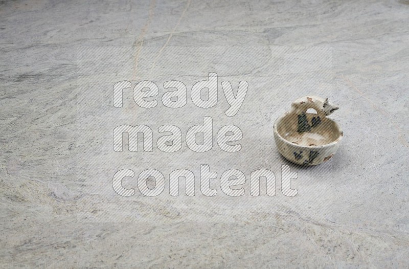 A Pottery Soap Dish On Grey Marble Flooring