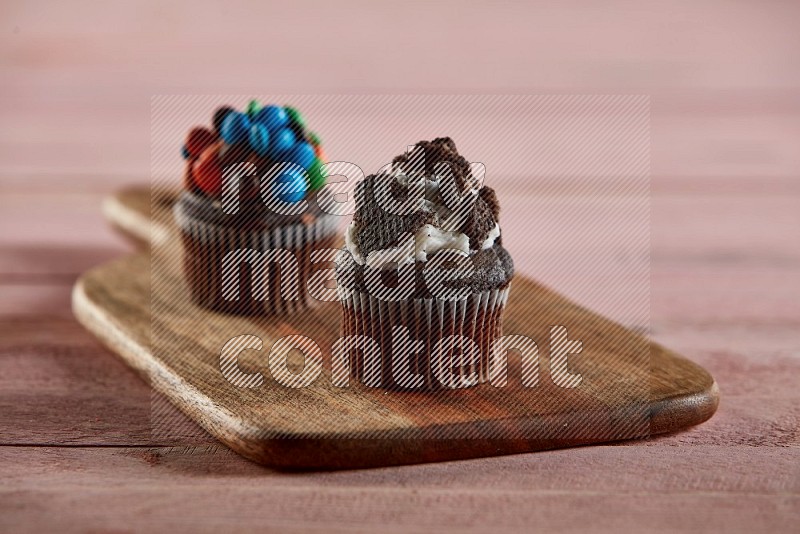 Chocolate mini cupcake topped with oreo on a wooden board