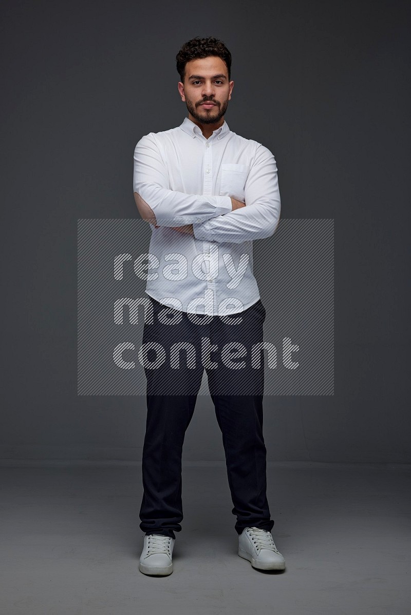 A man wearing smart casual making multi stand poses  eye level on a gray background