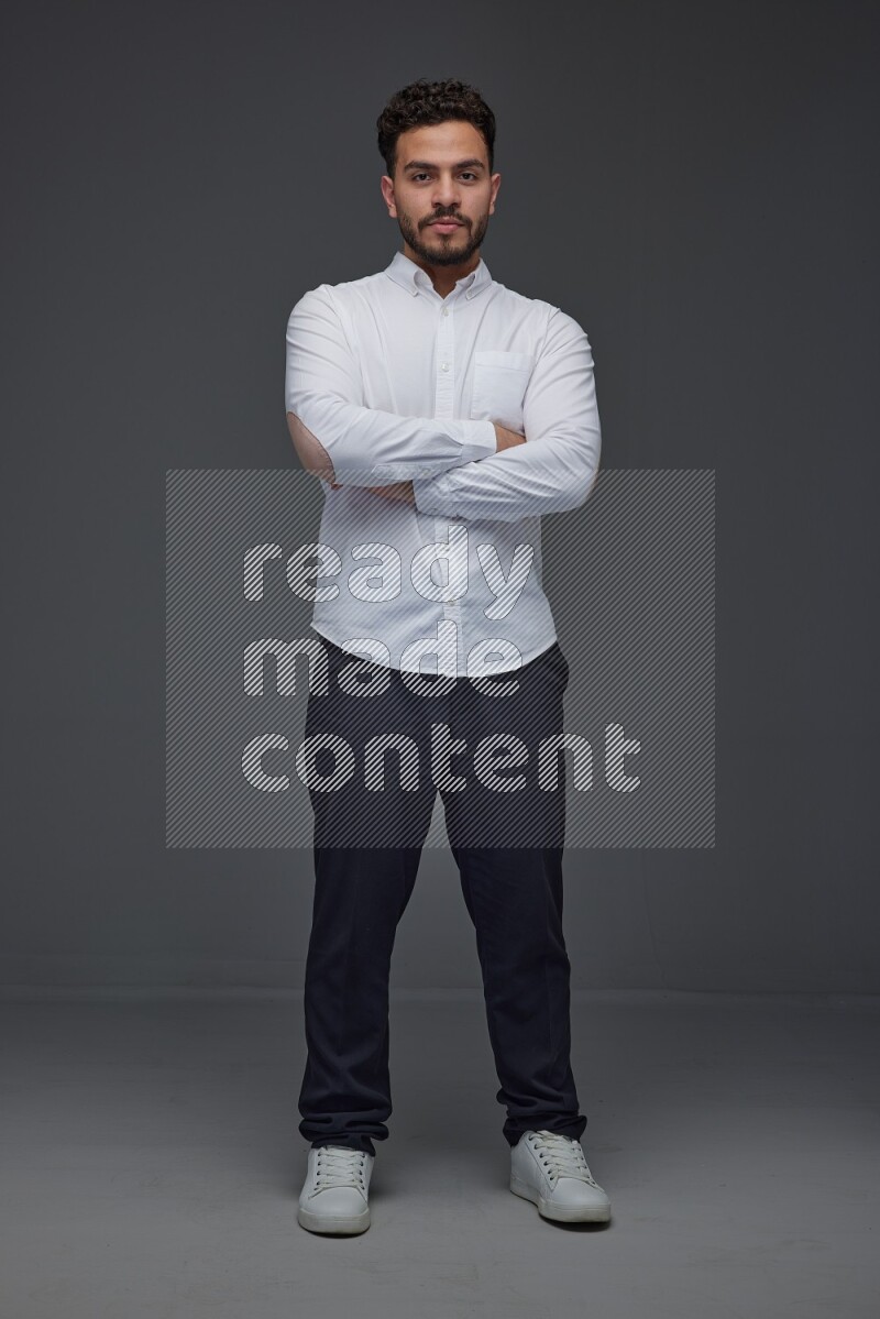 A man wearing smart casual making multi stand poses  eye level on a gray background