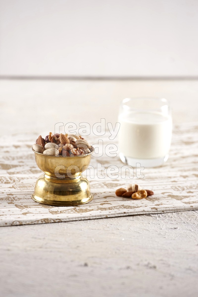 Nuts in a metal bowl with milk a light setup