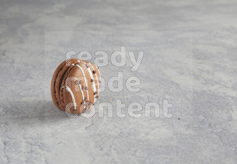 45º Shot of Brown white Chocolate Caramel macaron on white  marble background