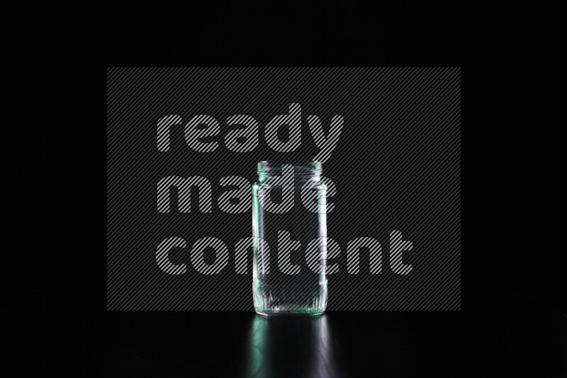 Glassware with rim light in green and white against black background