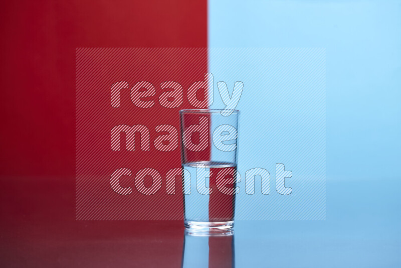 The image features a clear glassware filled with water, set against red and light blue background