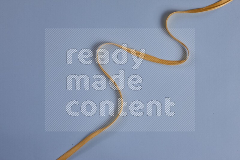 A yellow collection of sewing and tailoring tools arranged on a blue background