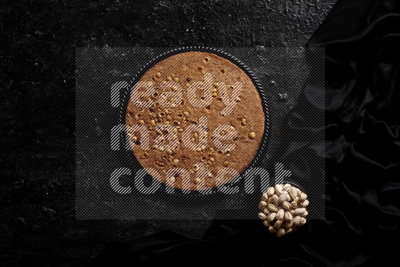 Basbousa with nuts and honey in a dark setup