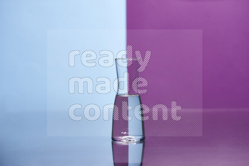 The image features a clear glassware filled with water, set against light blue and purple background