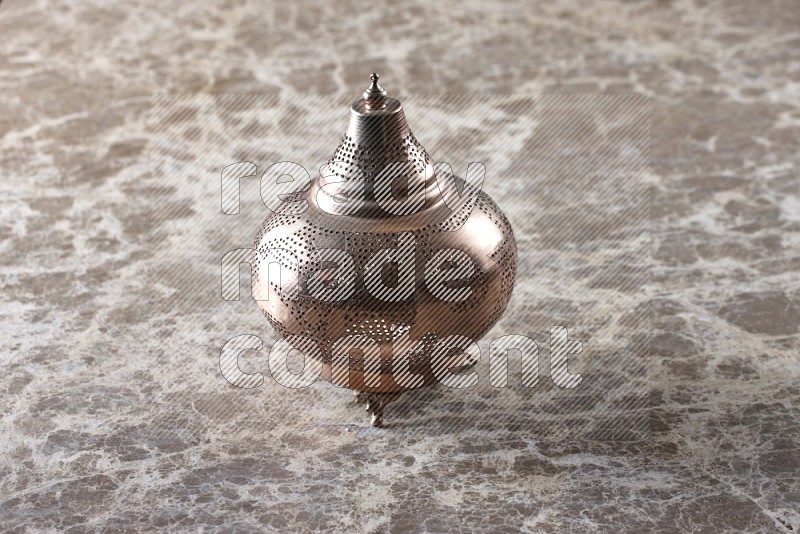 A lantern on beige marble background