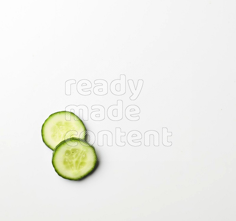 two cucumber slices on white background