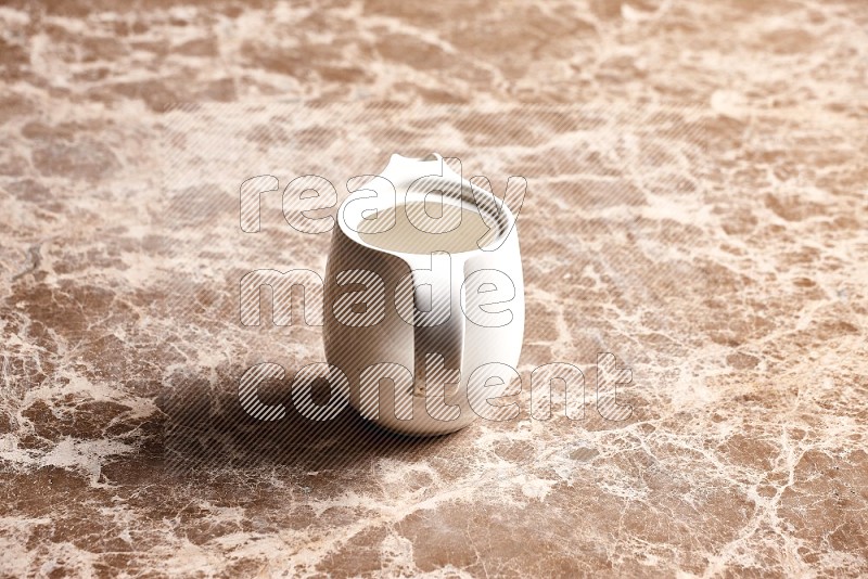 Ceramic Milk Jug on Beige Marble Flooring, 45 degrees