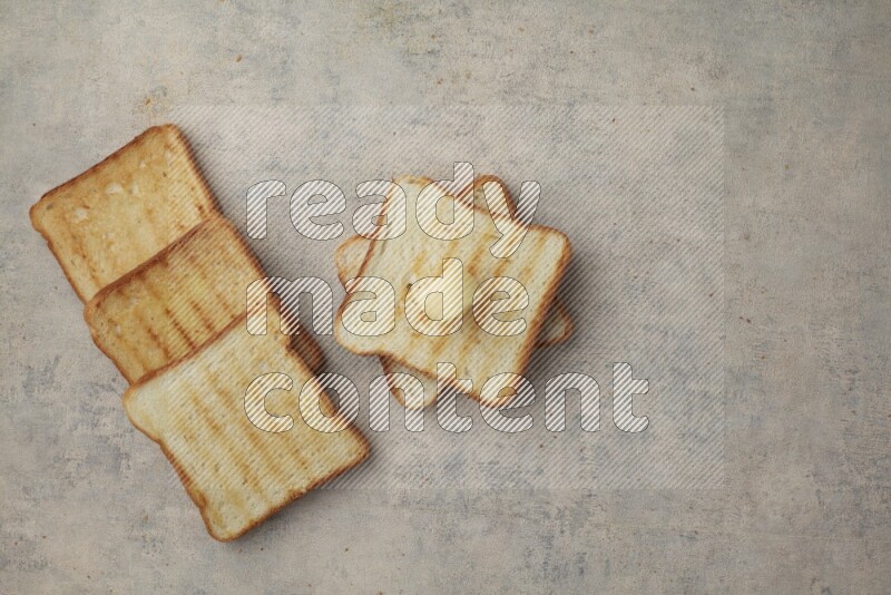 Toasted White Toast slices with a butter curl on a light blue textured background