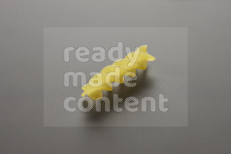 Fusilli pasta on grey background