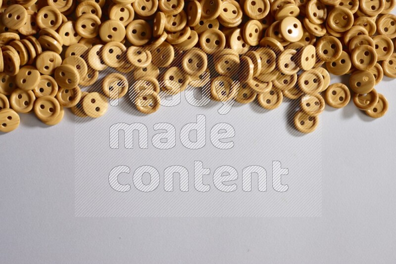 Wooden buttons placed on grey background