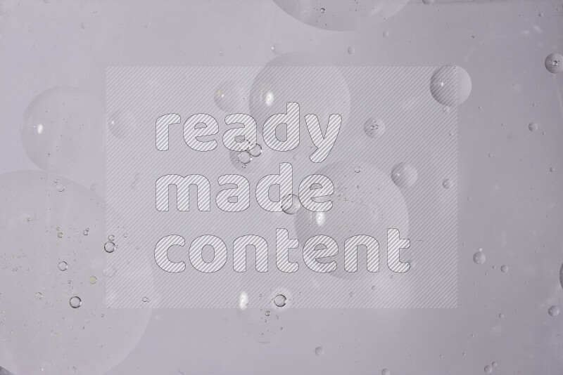 Abstract oil droplets in a water surface on white background