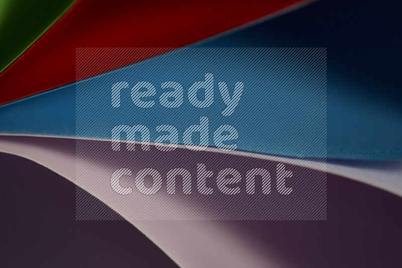 An abstract art showing colorful paper sheets arranged in an overlapping curves