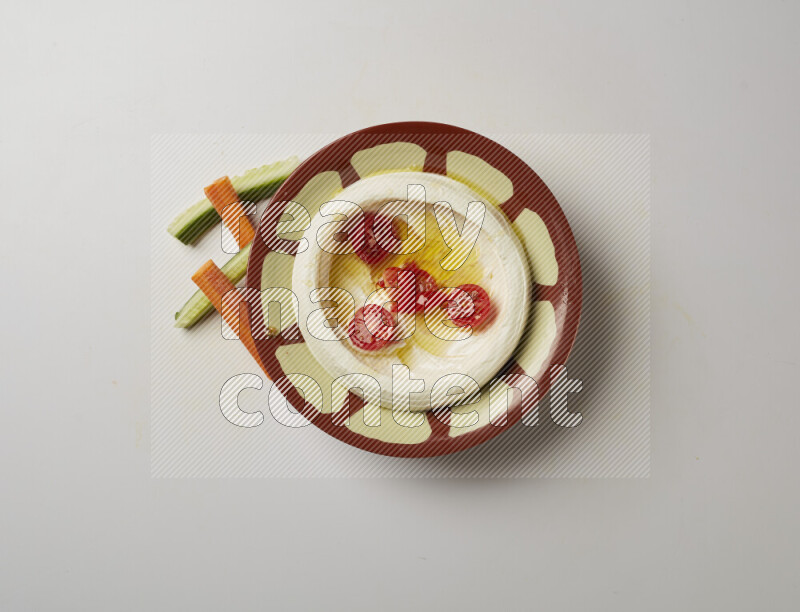Lebnah garnished with Cherry tomato in a traditional plate on a white background