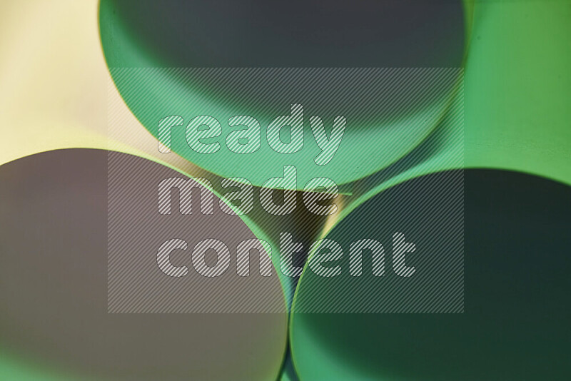 The image shows an abstract paper art with circular shapes in varying shades of green and warm tones