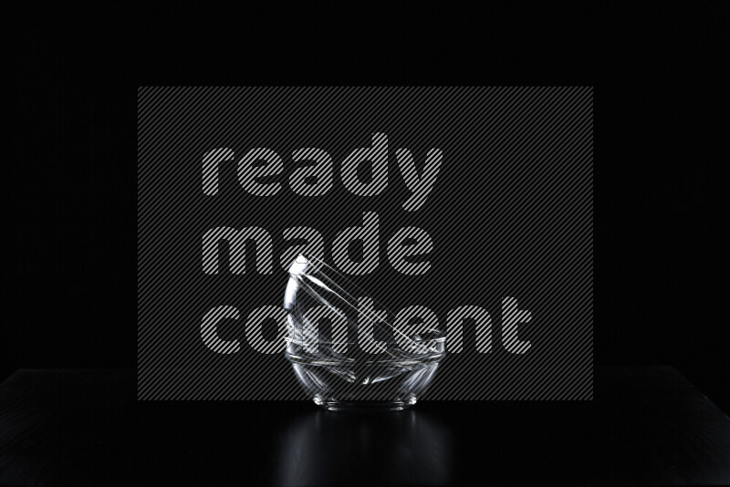 Glassware with rim light against black background