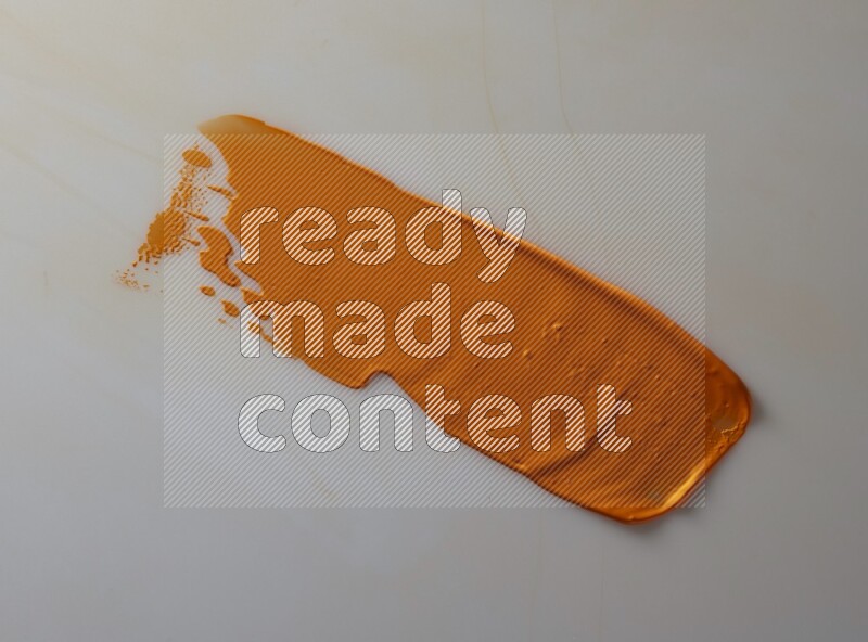 An orange straight painting knife stroke on white background