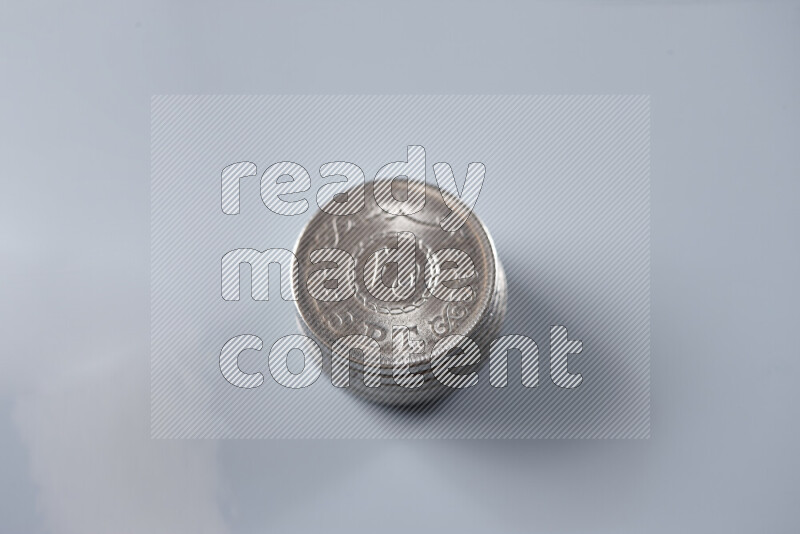 Stack Egyptian 25 piasters coins on grey background
