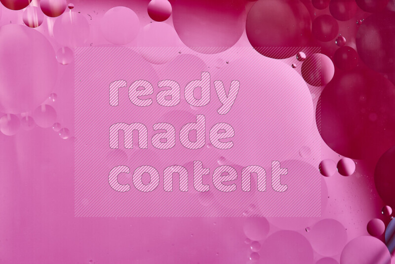 Close-ups of abstract oil bubbles on water surface in shades of red and pink