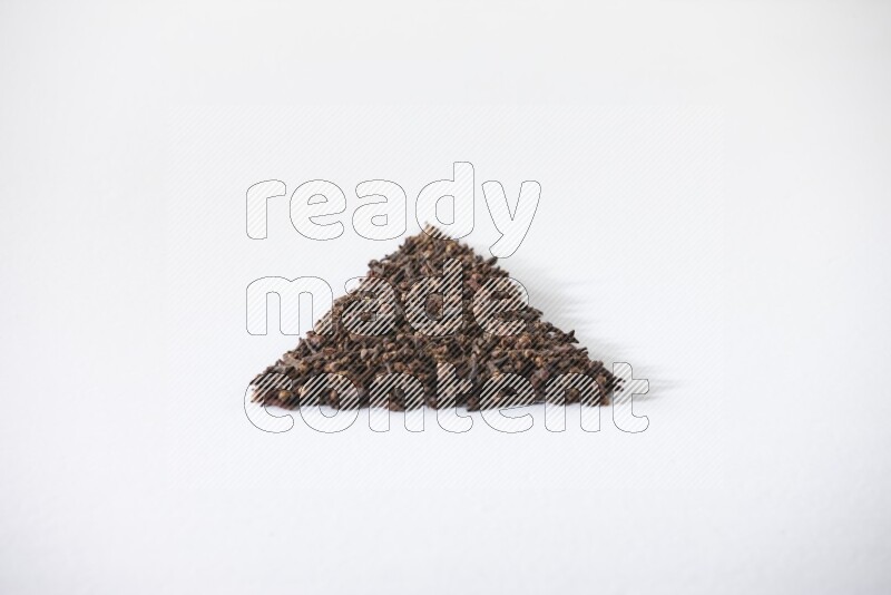 cloves in a triangle shape on a white flooring