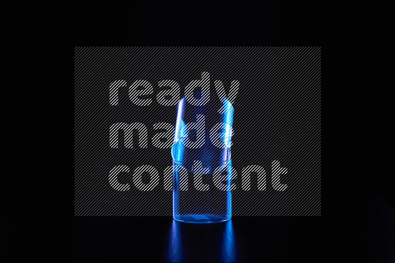 Glassware with rim light in blue against black background