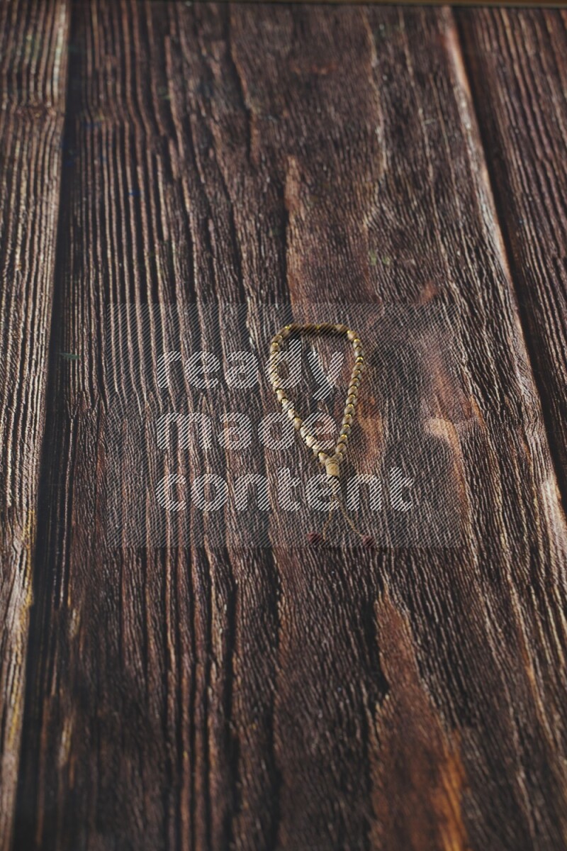 A prayer beads placed on wooden background