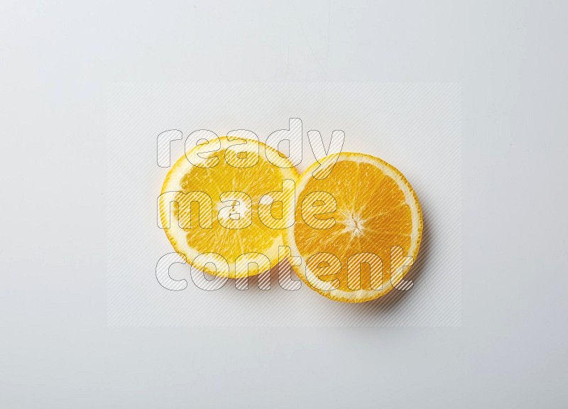Two orange slices on white background