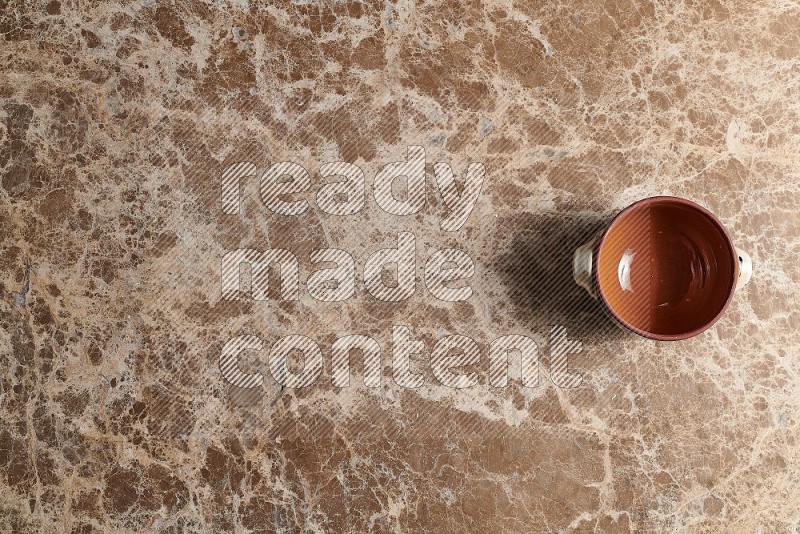 Top View Shot Of A Multicolored Pottery pot On beige Marble Flooring