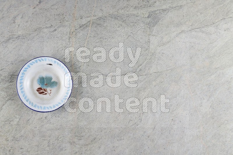 Top View Shot Of A Vintage Metal Plate On Grey Marble Flooring