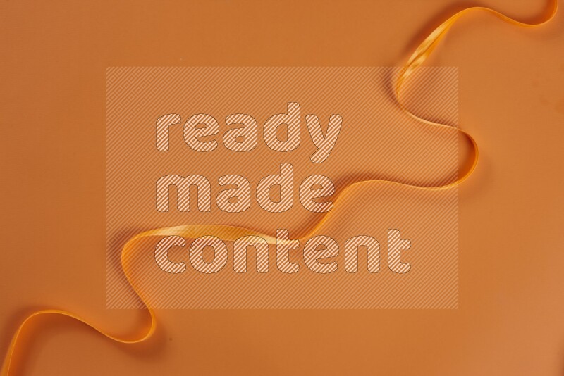 مجموعة من أدوات الخياطة والتفصيل برتقالية اللون على خلفية برتقالية