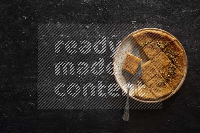 Konafa in different plates in a dark setup