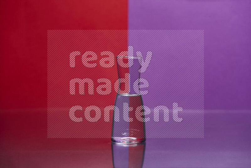 The image features a clear glassware filled with water, set against red and purple background