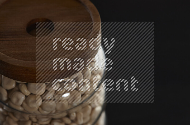 Lupin Beans in a glass jar on black background