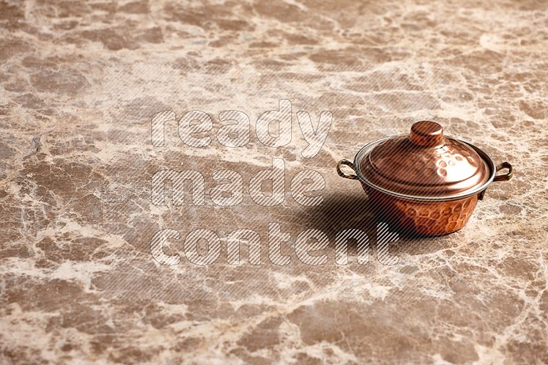 Small Copper Pot on Beige Marble Flooring, 45 degrees