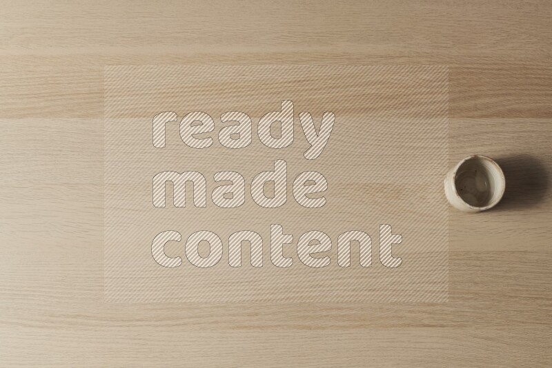 كأس فخاري على خلفية خشبية فاتحة