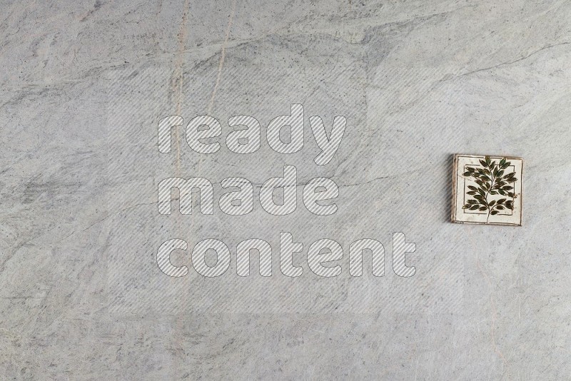 Top View Shot Of A Pottery Coaster tile On Grey Marble Flooring