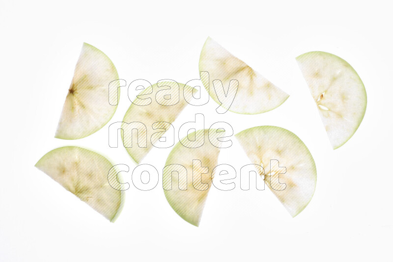 Apple slices on illuminated white background