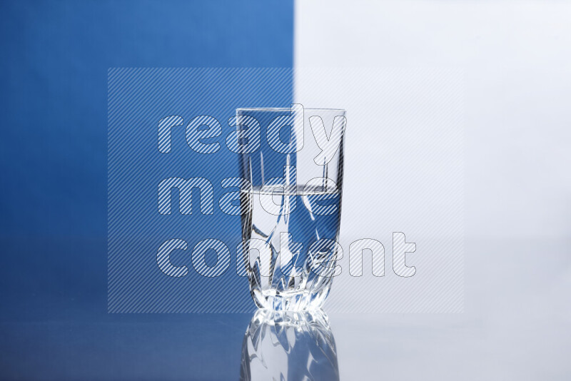 The image features a clear glassware filled with water, set against white and blue background