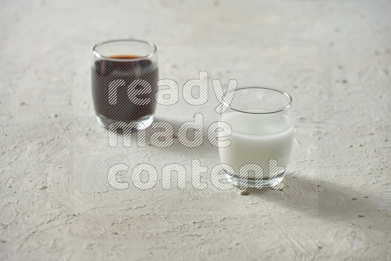 Cold drinks in a glass cup such as water, tamarind, qamar eldin, sobia, milk and hibiscus on textured white background