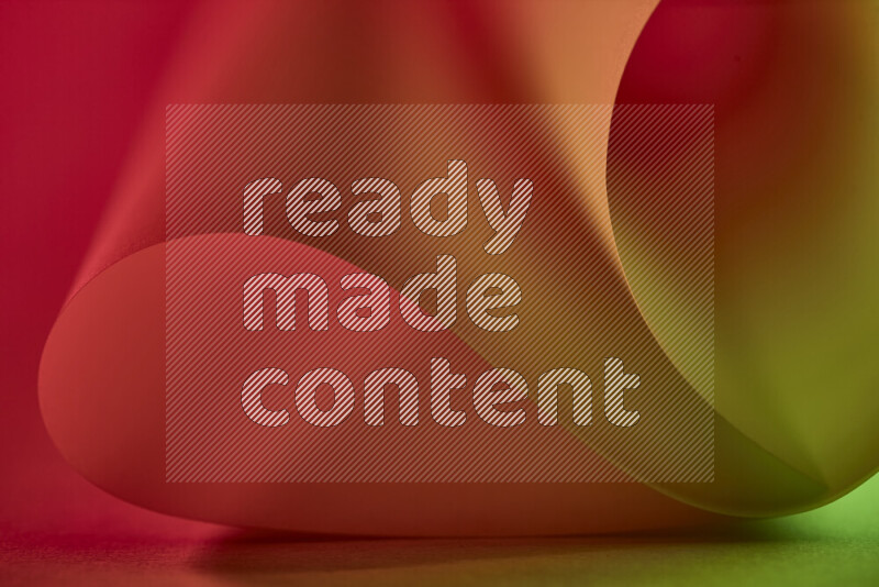 An abstract art piece displaying smooth curves in green and red gradients created by colored light