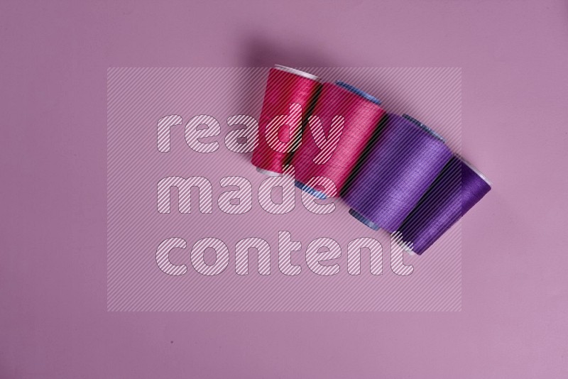 Purple sewing supplies on pink background