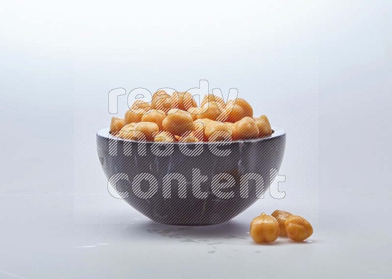 Close up of a boiled chickpeas in a container on white background